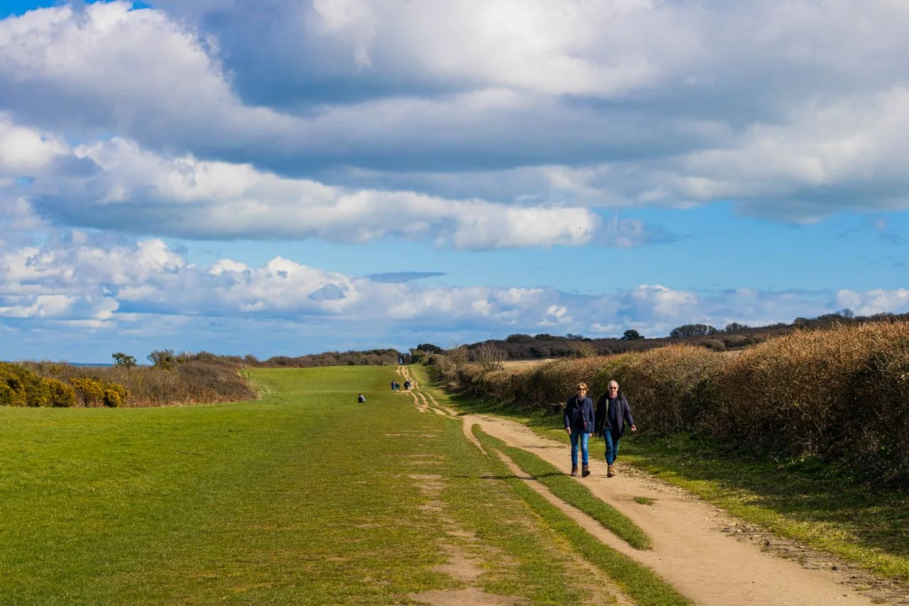 Couple walking on a long country road — emotional regulation after betrayal by Matt Wenger, Begin Again Institute